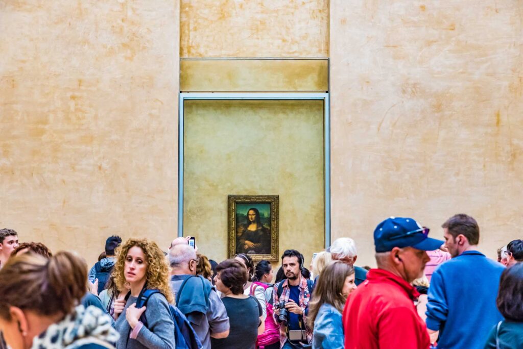 People staring at Monalisa painting in the Louvre Museum, Paris
