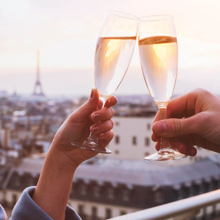Couple toasting champagne glasses in Paris