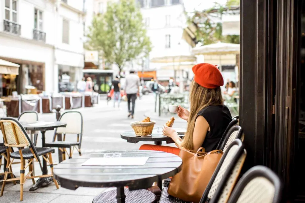 Woman in a Paris cafe wearing a red beret