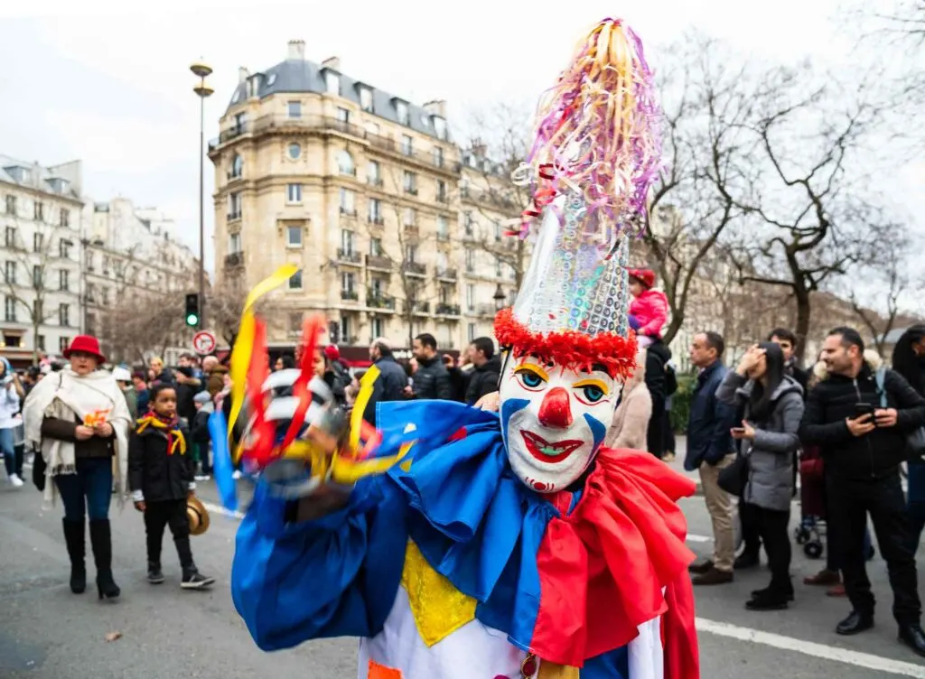 Man in clown costume at traditional Carnival in Paris