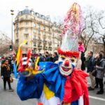 Man in clown costume at traditional Carnival in Paris
