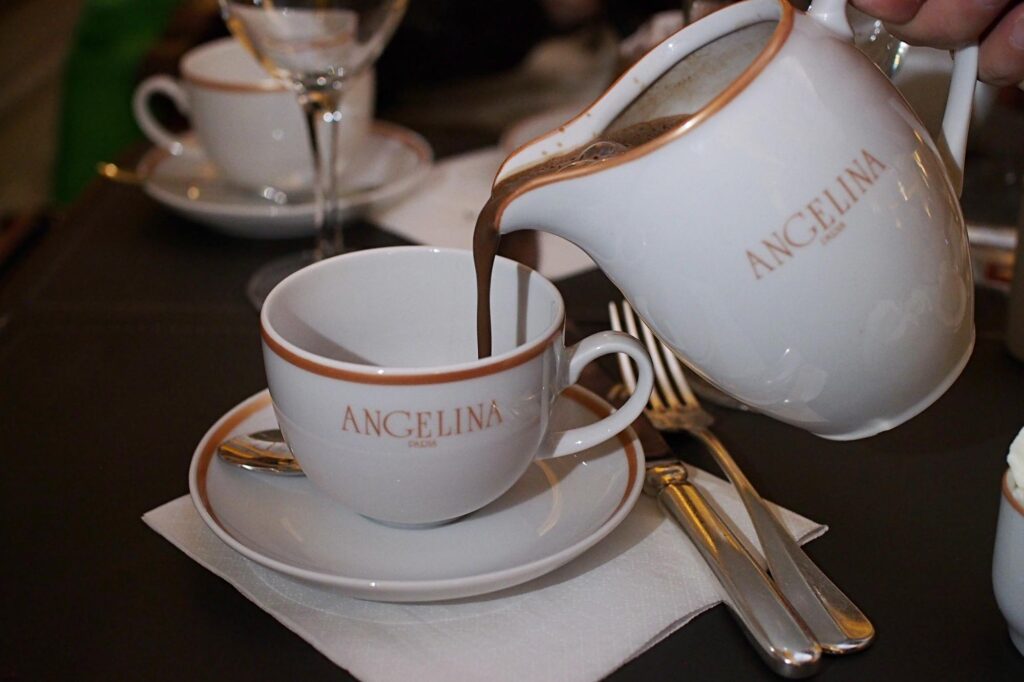 Pouring hot chocolate from small jug at Angelina