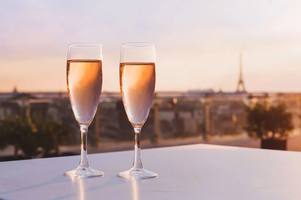 two glasses of champagne at rooftop restaurant with view of Eiffel Tower, Paris