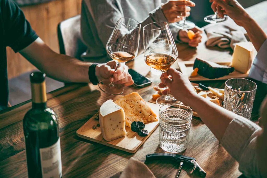 Wine and cheese served on table
