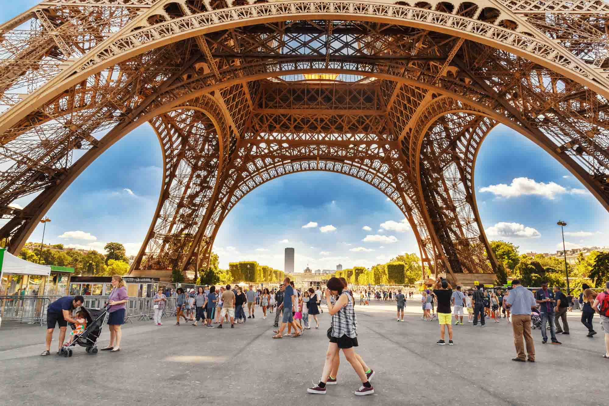 Tourists walking under Eiffel tower