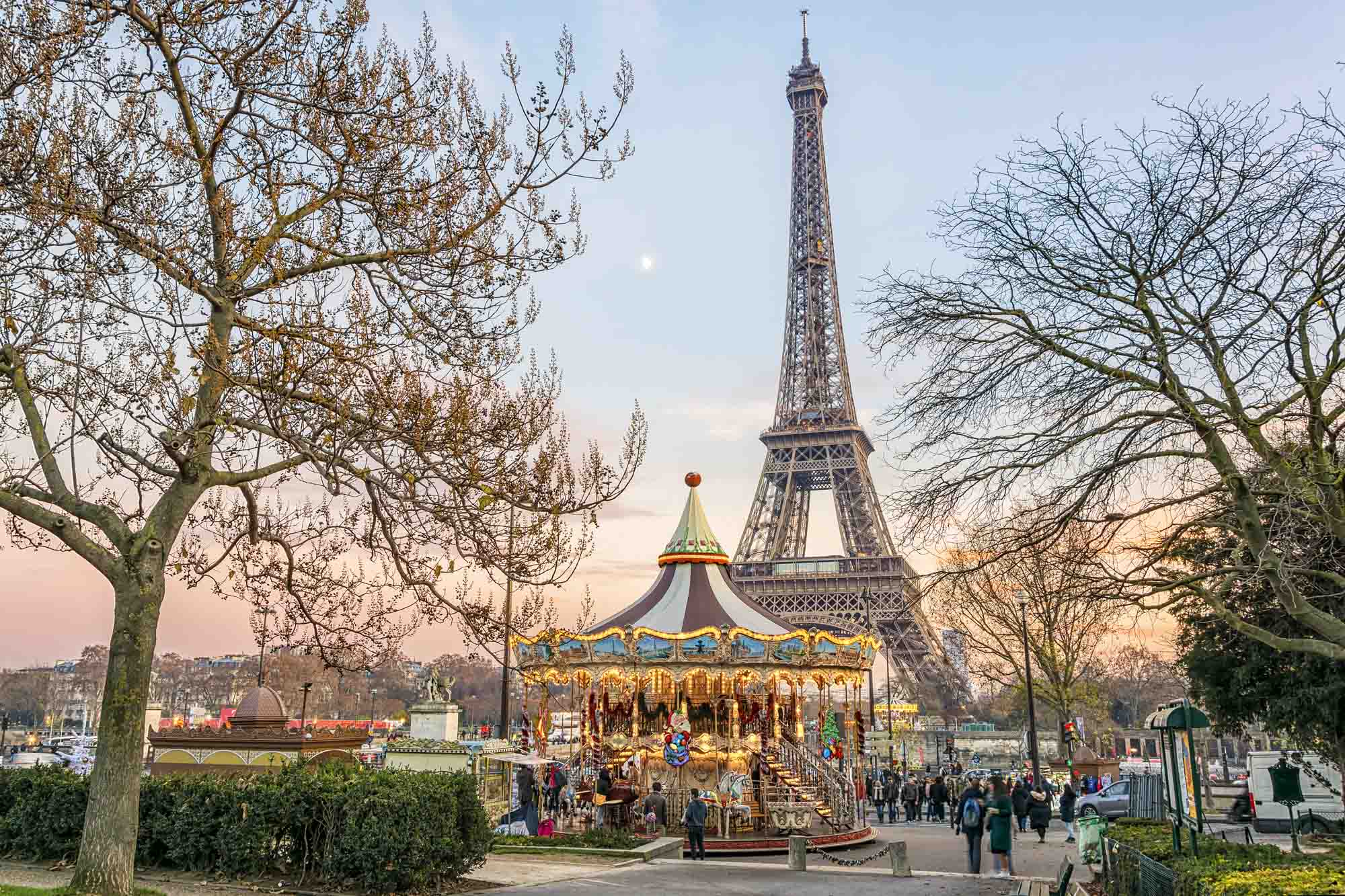 Eiffel Tower and vintage carousel in Paris at sunset during winter