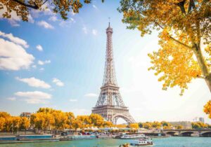 Eiffel Tower over Seine river with autumn trees