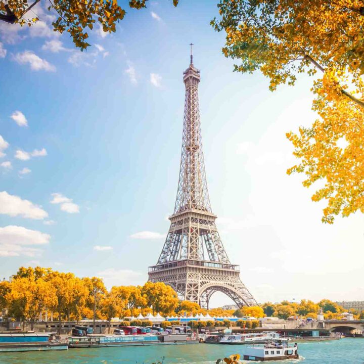 Eiffel Tower over Seine river with autumn trees