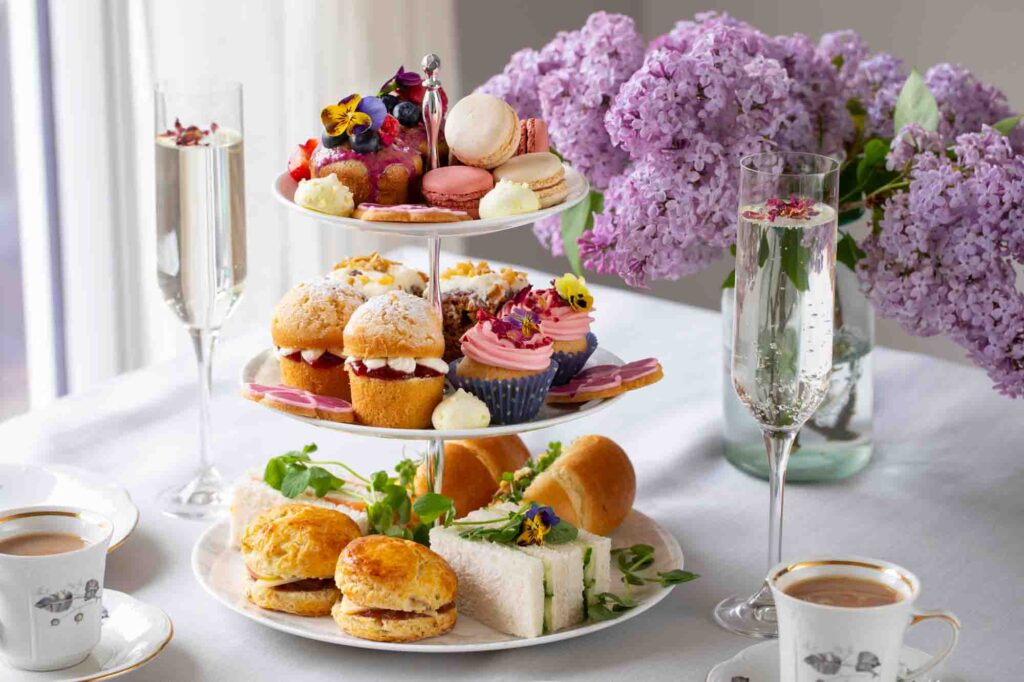 Traditional Paris afternoon tea with selection of cakes and sandwiches