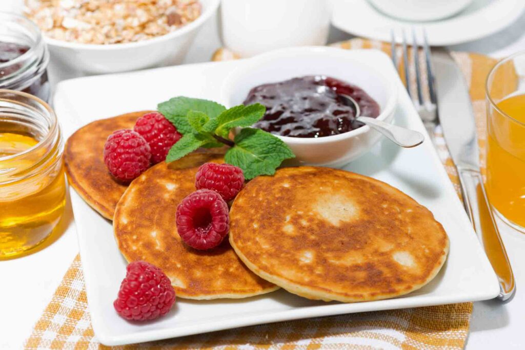 pancakes with raspberries and jam for breakfast